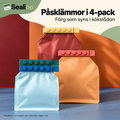 Fyra färgade påsklämmor med upphöjda cirklar på påsar. Miljöbild.